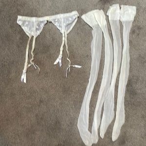 White lace garter belt with 2 pair stockings. Size large from Victoria’s Secret.